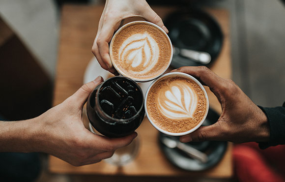 Three people holding cup of coffee